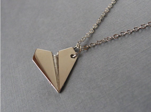 One Direction: Harry Style's paper airplane necklace.